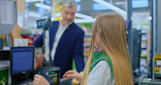 cashier scanning goods of customer in supermarket, saleswoman works with cash-desk, 4K, Prores