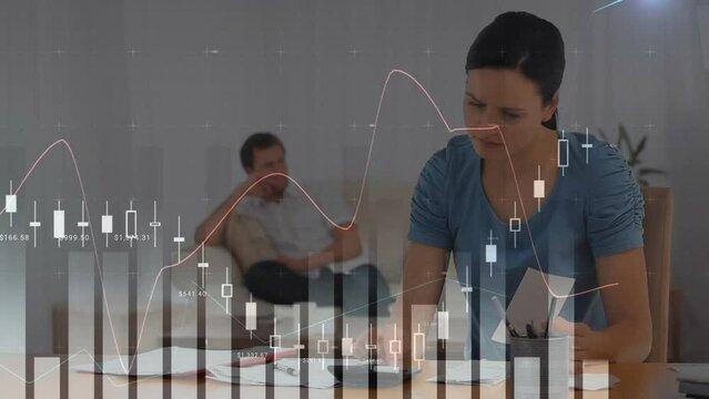 Animation of multiple graphs moving over caucasian woman calculating pending bills at home