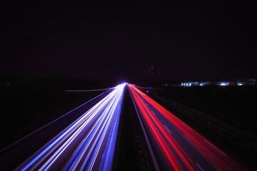 Fototapeta na wymiar Langzeitbelichtung - Autobahn - Strasse - Traffic - Travel - Background - Line - Ecology - Highway - Long Exposure - Motorway - Night Traffic - Light Trails - High quality photo 