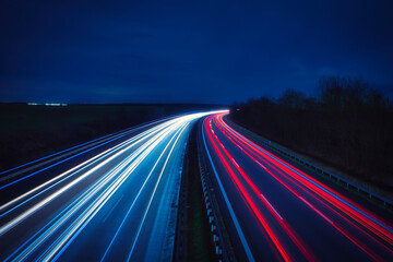 Fototapeta na wymiar Langzeitbelichtung - Autobahn - Strasse - Traffic - Travel - Background - Line - Ecology - Highway - Long Exposure - Motorway - Night Traffic - Light Trails - High quality photo 