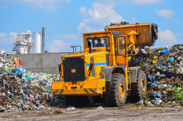 Wheel loader on landfill. Sorting rubbish by wheel loader 