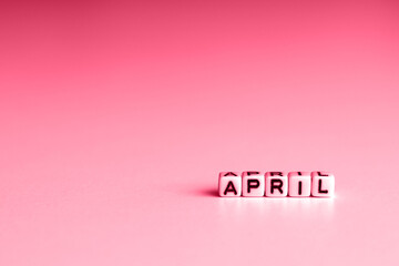 The April image of the January wooden color calendar. Cubes of the "January" icon. The new trend color Viva Magenta 2023