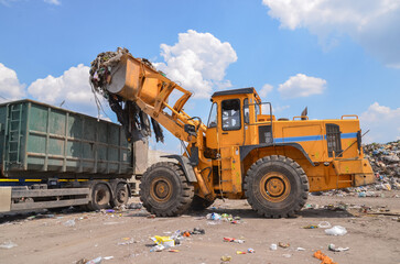 Wheel loader on landfill. Sorting rubbish by wheel loader 
