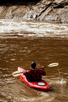 A middle age man paddles his whitewater kayak down the Salt River in Arizona.
