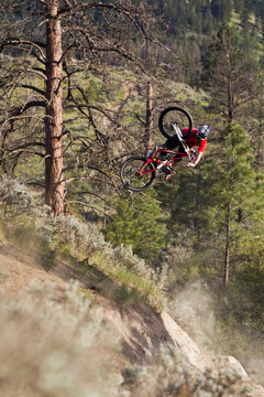 Mountain biker styles a jump, Kamloops, BC
