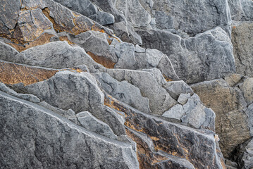 Full frame close-up of layered, slate-like structures of volcanic basalt rocks at Djúpalónssandur beach, Snæfellsnes, Iceland, also suitable as geological background texture