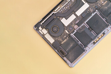 The top view on an open dirty and dusty laptop on a yellow background. Engineer. Heating. Tech....