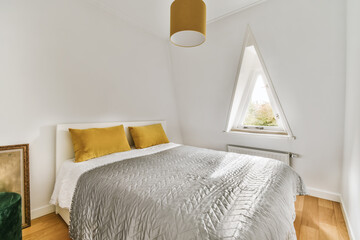 a bedroom with white walls and wood flooring the room has a large bed that is made up to look like...