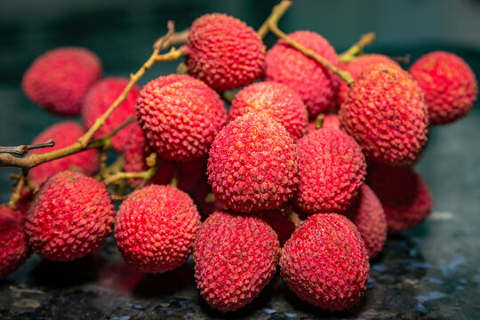 Ripe lychee fruit (Litchi chinensis) isolated in dark background and selective focus
