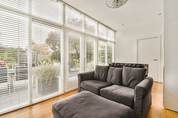 a living room with wood flooring and white shutters on the windows in this photo is taken from...