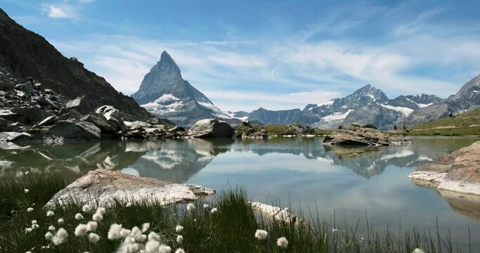 Panoramic view of Matterhorn reflected in Riffelsee lake - People Passing