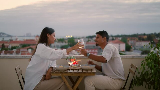 Happy spouses drinking champagne at terrace zoom out. Gentle man treating wife
