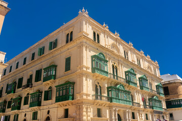 Fototapeta na wymiar Valletta, Malta, 22 May 2022: Buildings with traditional maltese balconies in Valletta old town