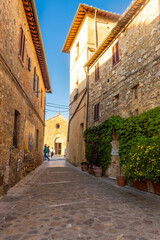 Monteriggioni,  Italy, 17 April 2022: historic center of the medieval town at sunset