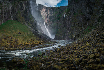 Voringsfossen waterfall with steep mountain cliffs in the valley at Hardangervidda National Park in Norway