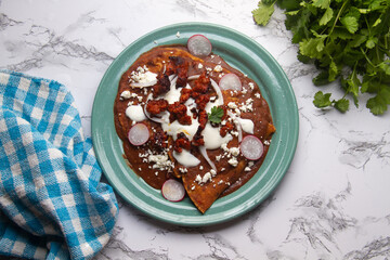 Mexican enfrijoladas with chorizo and fresh cheese