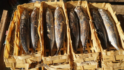 Pindang fish packed in a bamboo basket at a traditional market in Indonesia