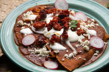 Mexican enfrijoladas with chorizo and fresh cheese
