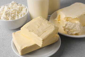 Tasty homemade butter and dairy products on white textured table, closeup