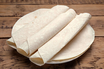 Delicious rolled Armenian lavash on wooden table