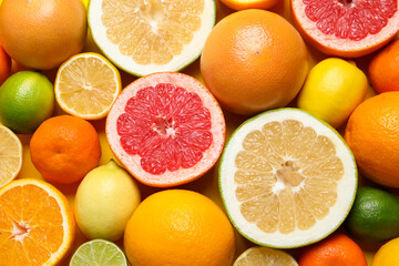 Different ripe citrus fruits as background, top view