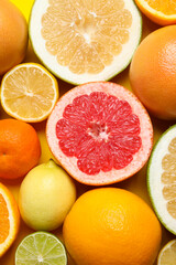Different ripe citrus fruits as background, top view