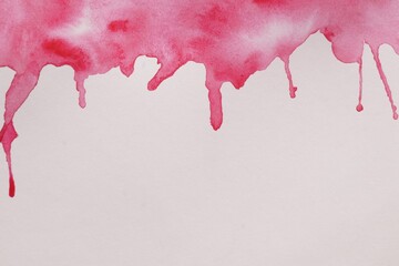 Magenta watercolor blots on white canvas, top view. Space for text