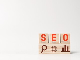 Concept of SEO with icons on wooden blocks.
