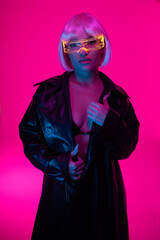 A girl in the cyberpunk style. Girl in neon with luminous glasses