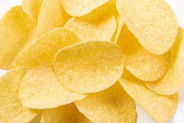 Pile of potato chips on white background.