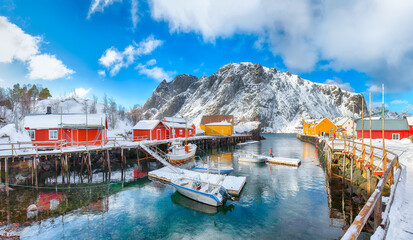 Stunning morning seascape of Norwegian sea and cityscape of Nusfjord village.