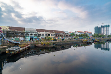 HOCHIMINH CITY, VIETNAM - JANUARY 29, 2022: Morning at Flower market on Tet holiday "Tren Ben Duoi Thuyen" every year at Binh Dong Wharf, District 8. Boats are shake by water, blur foreground
