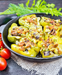 Pepper stuffed with vegetables in pan on board