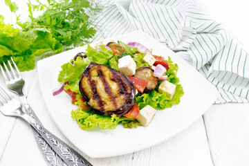 Salad of eggplant with cheese and tomatoes on light board