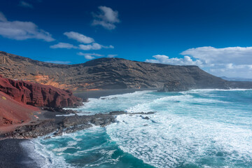 Fototapeta na wymiar Lanzarote, Spain, 20 March 2022: The Atlantic Ocean at El Golfo black volcanic beach