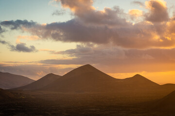 Fototapeta na wymiar Beautiful silhouette of Lanzarote volcanos at sunset, Canary Islands, Spain
