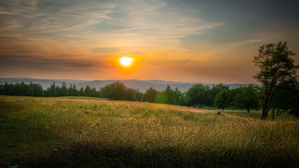 Obraz premium Beautiful sunset over farmlands in the Swiss Alps - travel photography