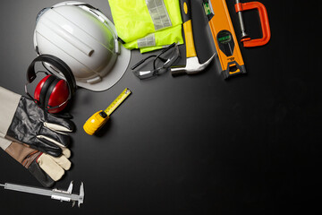 Work safety. Construction site protective equipment on wooden background, flat lay, copy space, top view