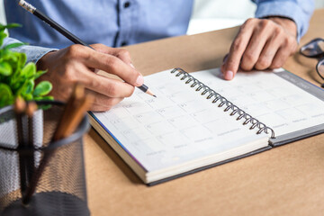 Businessman agenda calendar and reminder agenda work online at home men plan daily appointments and vacation travel journals in a diary at their desk . calendar reminder event concept .	
