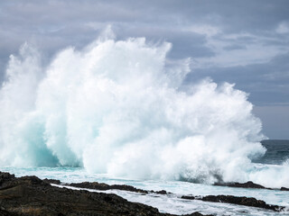 Wave breaking onto rocks.