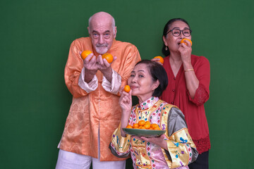 Chinese family from different ethnicities wearing oriental clothes, getting together to celebrate The New Lunar Year 2023