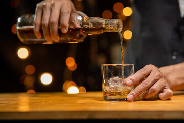 Barman pouring whiskey whiskey glass beautiful night