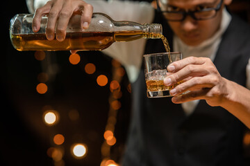 Barman pouring whiskey whiskey glass beautiful night