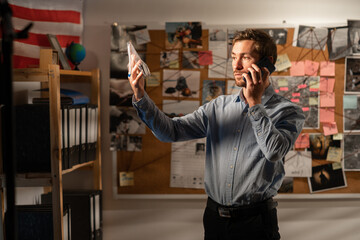 Detective working in an office with a gun as evidence