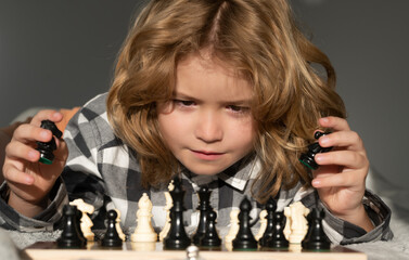 Clever thinking child. Kid playing chess. Clever child thinking about chess. Kids early development.