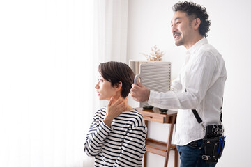 A hairdresser checking the finished cut.