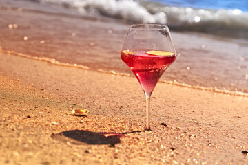 Wine glass with a cocktail by the sea.
