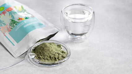 A source of biologically active substances, a food additive, herbal preparations, sprouted grains and vegetables, a superfood in dry form for adding to water and food, on a light background