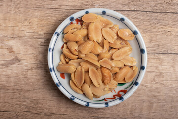 salted roasted peanuts on wooden background