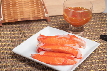 Boiled crab sticks with spicy and sour sauce